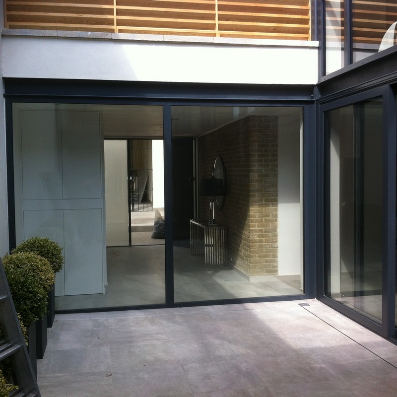 Floor-to-ceiling sliding doors opening to courtyard in Stratford