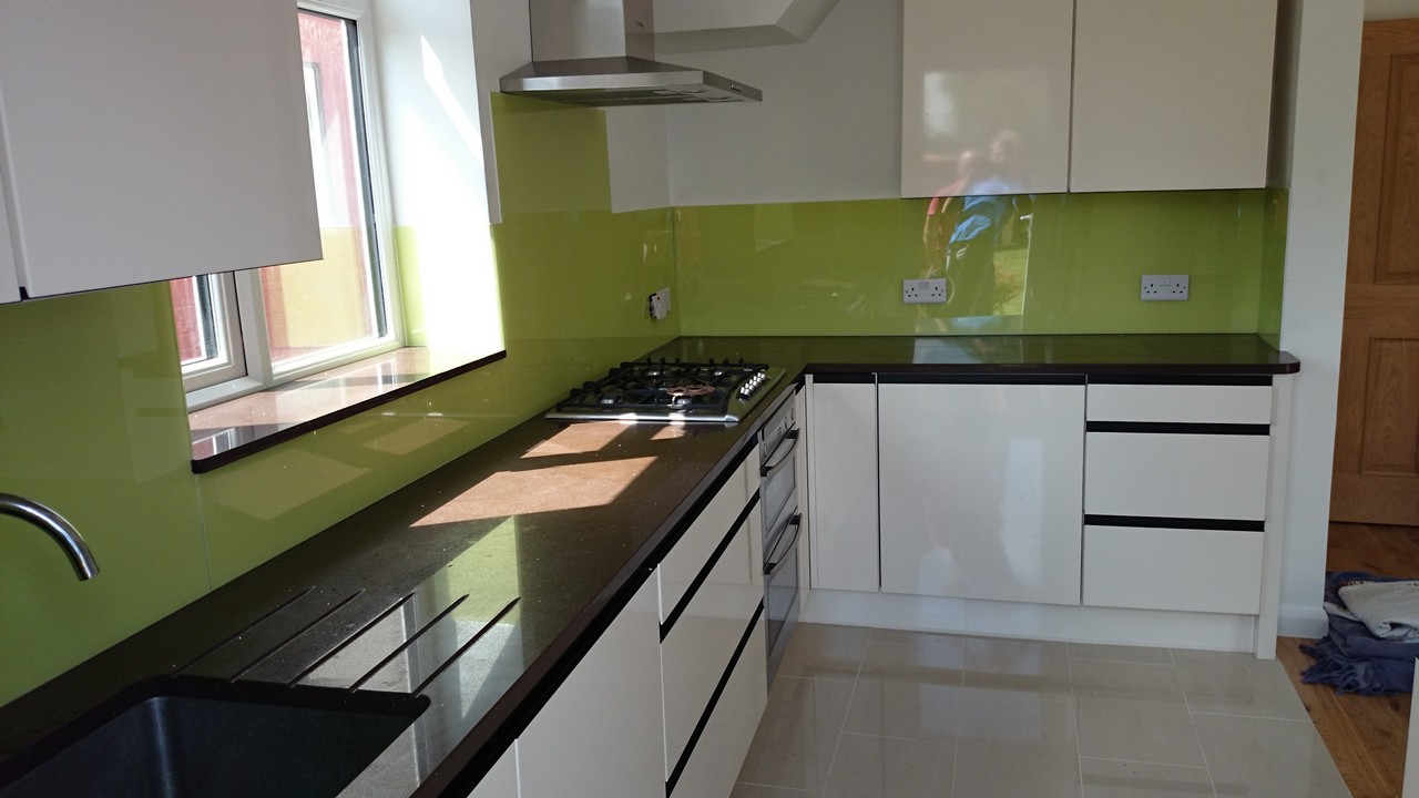 Lime green glass kitchen splashback installed by Stratford glaziers