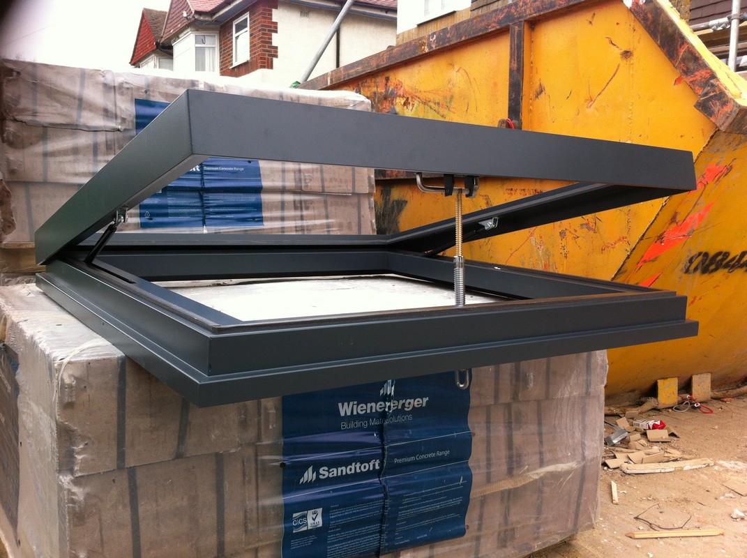 Opening flat roof skylight in anthracite grey installed in Stratford