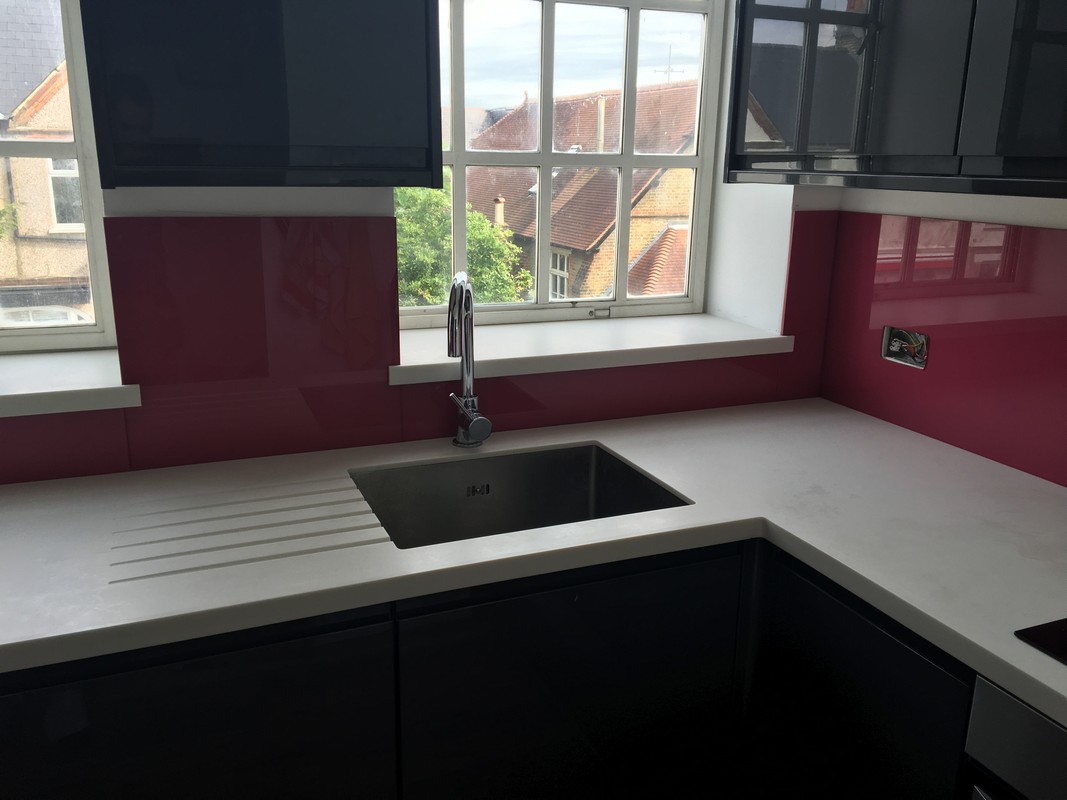 Deep plum coloured glass splashback in modern Stratford kitchen